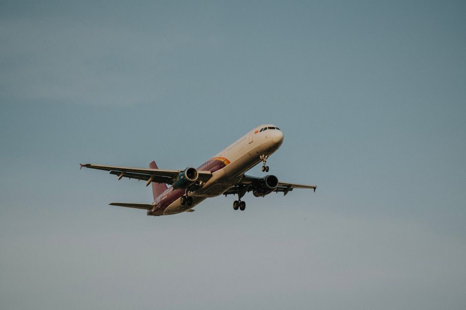 Photo by Văn Nguyễn Hoàng A commercial airplane flying against a clear blue sky, showcasing travel and aviation.