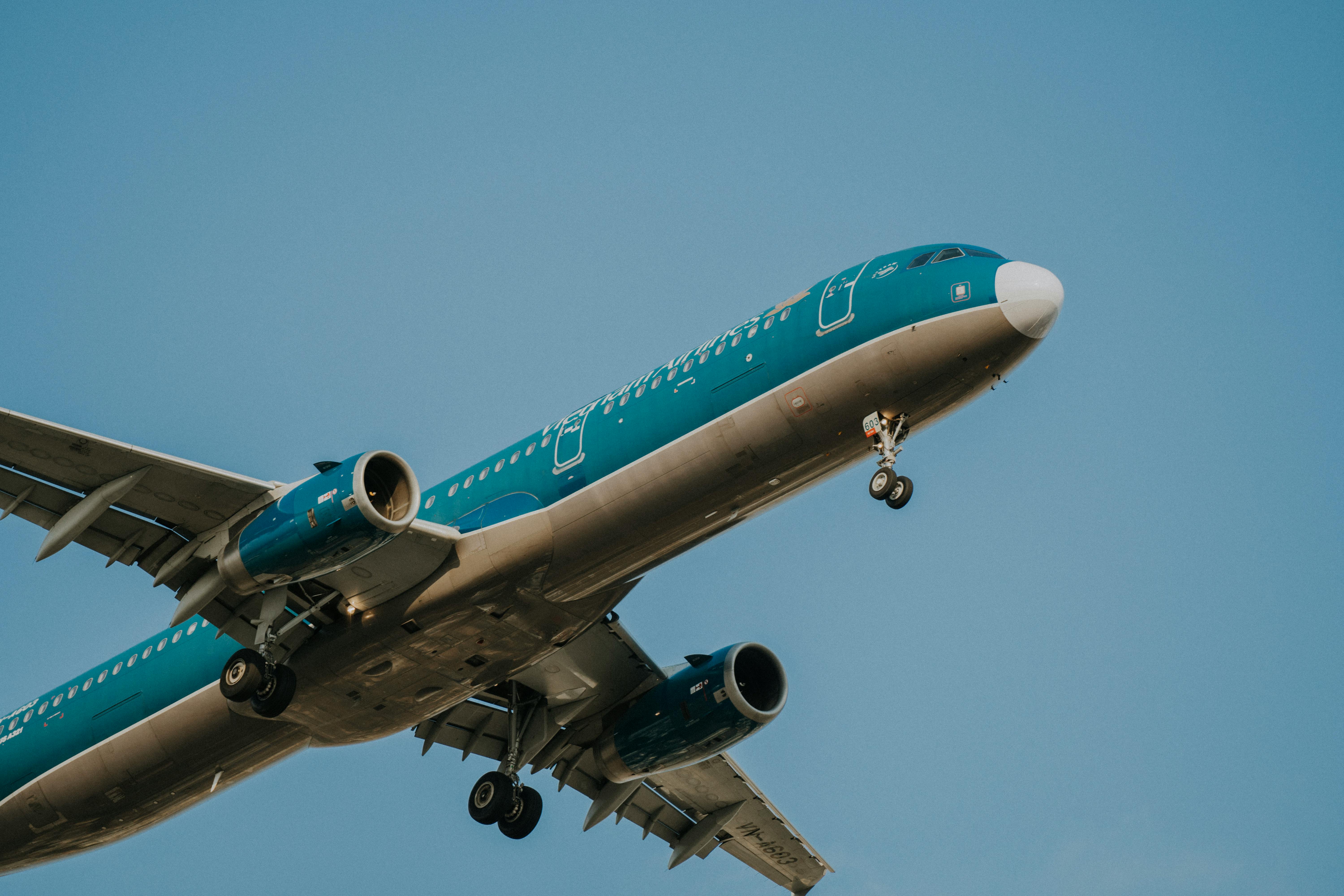 Free A Vietnam Airlines passenger airplane in flight, clear blue sky backdrop. Stock Photo
