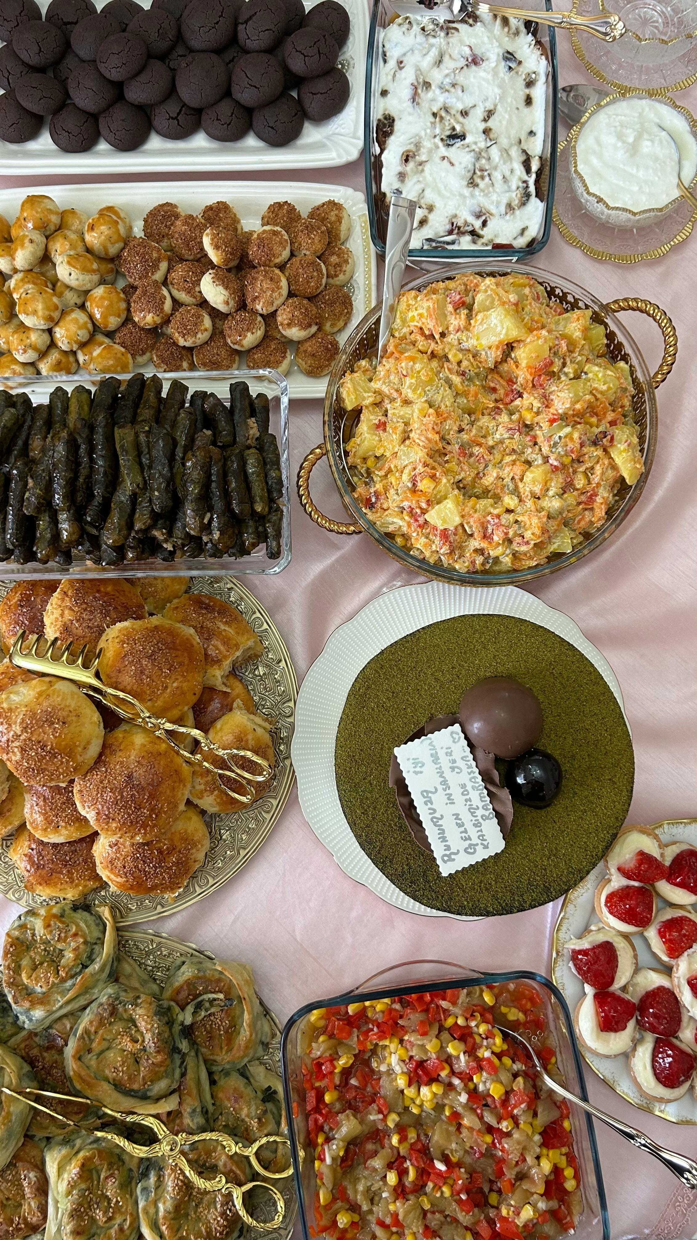 A luxurious spread of various dishes and desserts beautifully arranged on a table for a celebration.