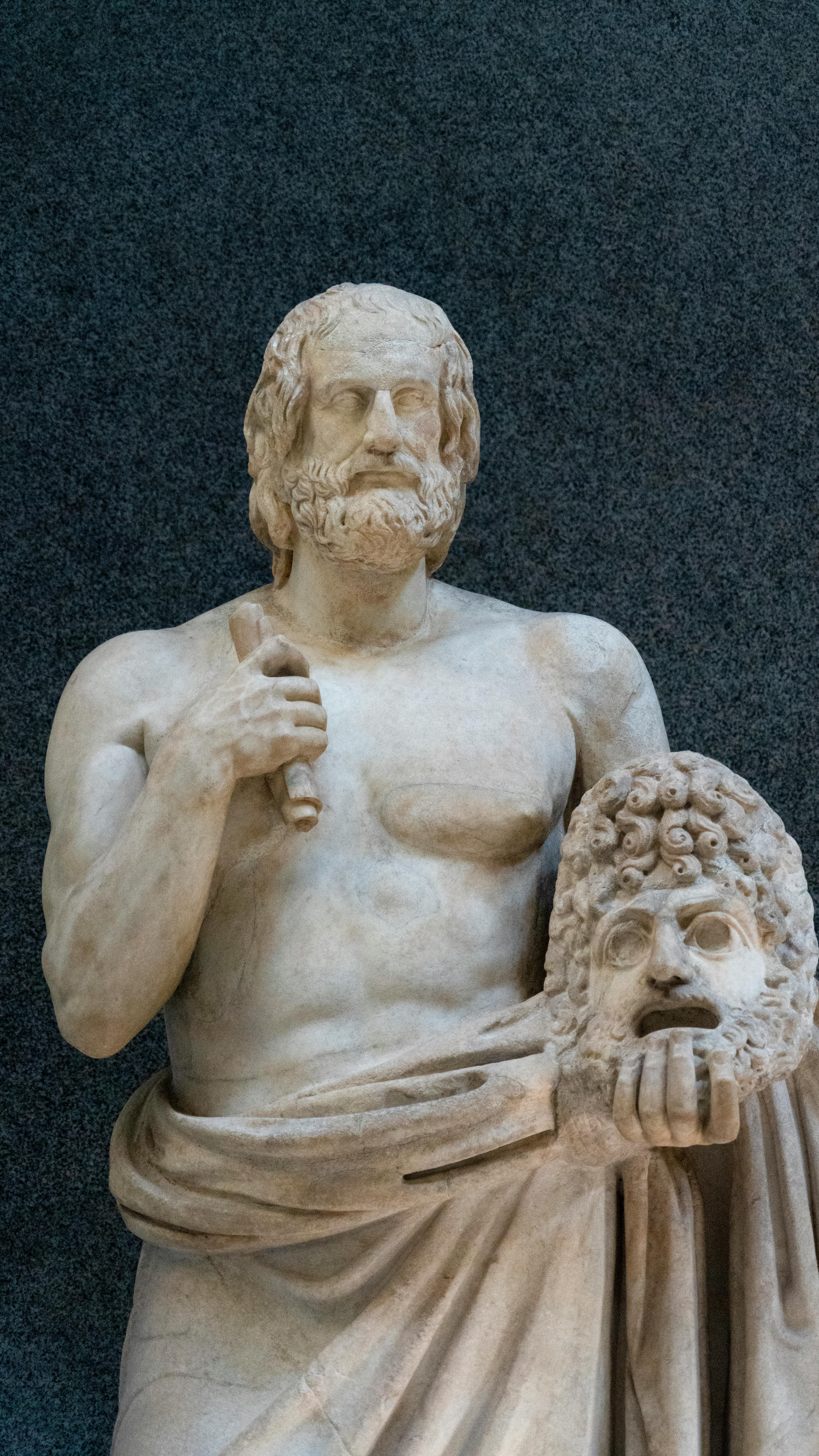 ancient sculpture of man holding head