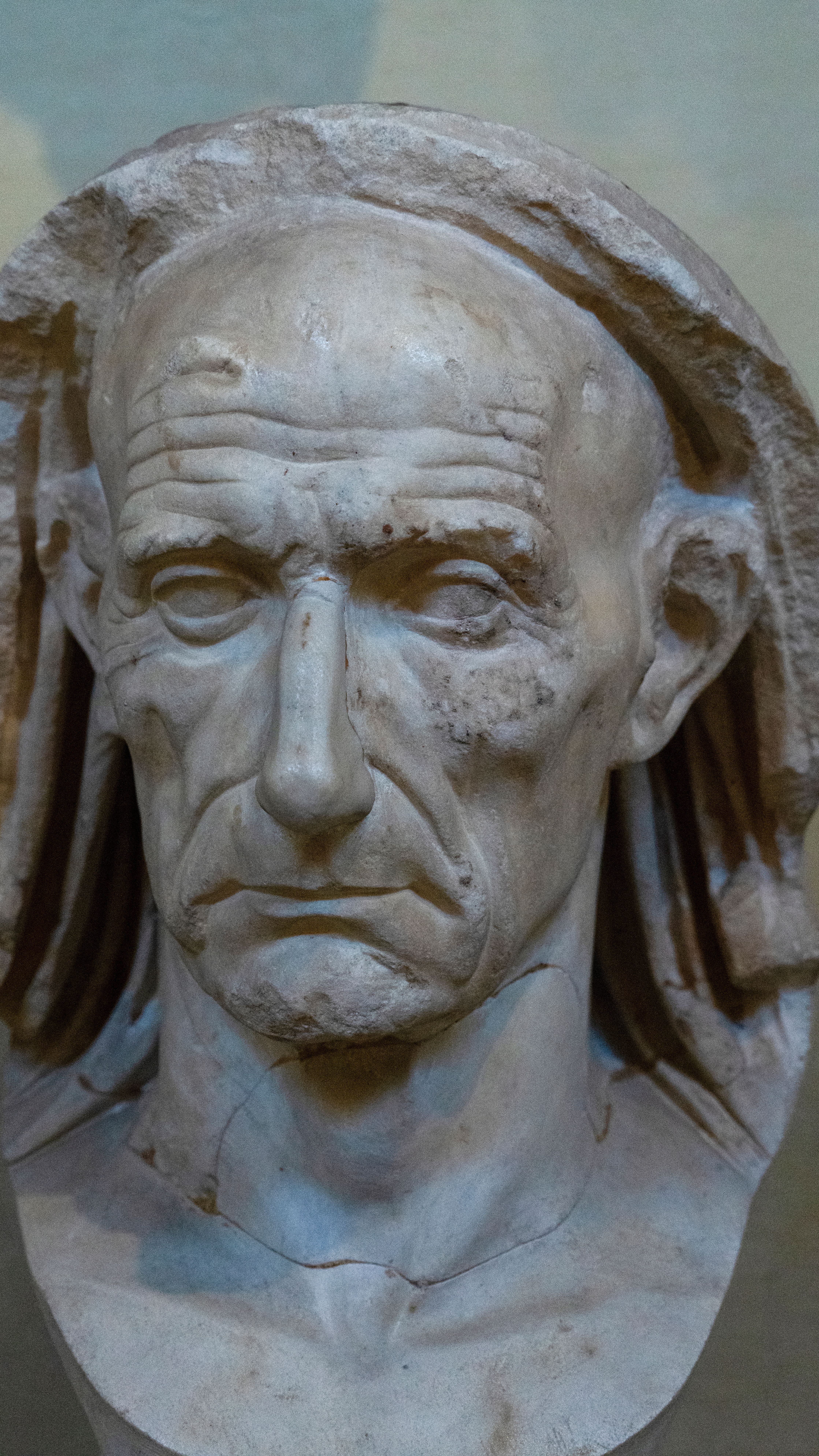 Intricate marble bust of an elderly Roman statesman showcasing classical artistry.