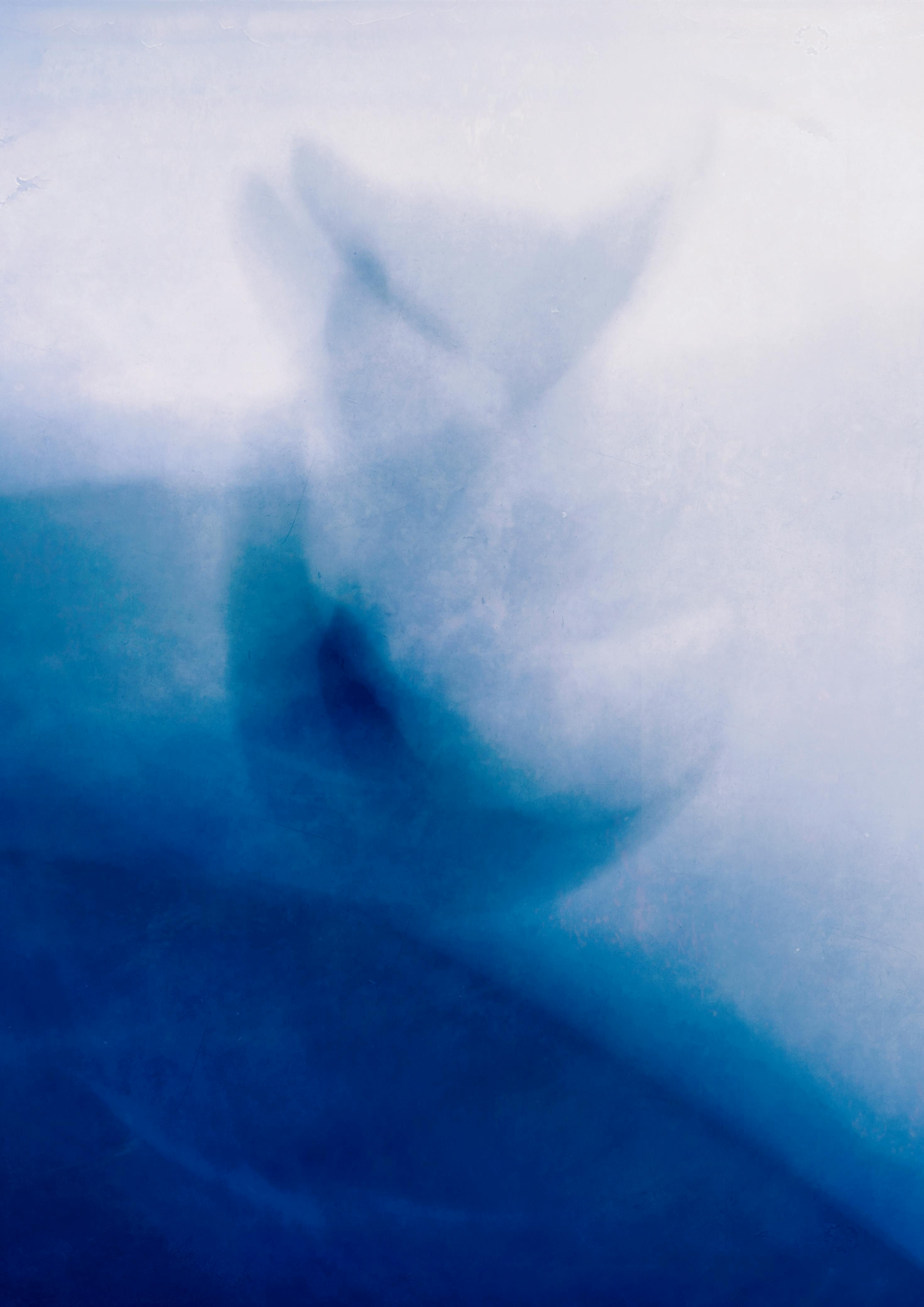 Ethereal abstract of ocean waves with blurred blue tones, evoking a serene and mystical underwater ambiance.