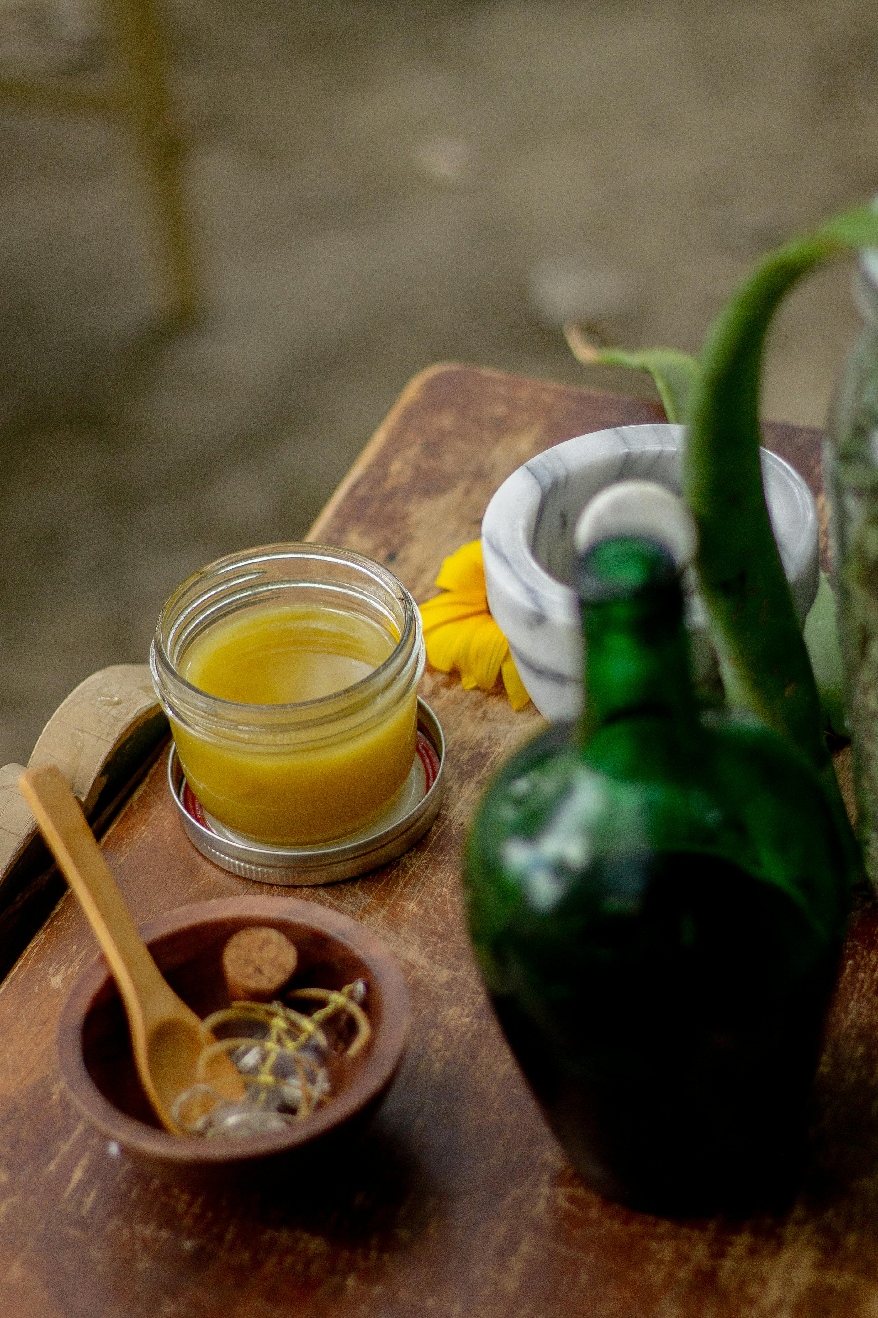 Frangipani and jasmine blossoms arranged beside bowls of coconut massage oil used in a traditional Balinese massage