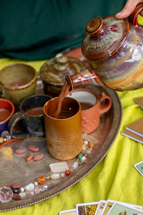 Kettle Pouring Cacao into Mugs for Ceremony 