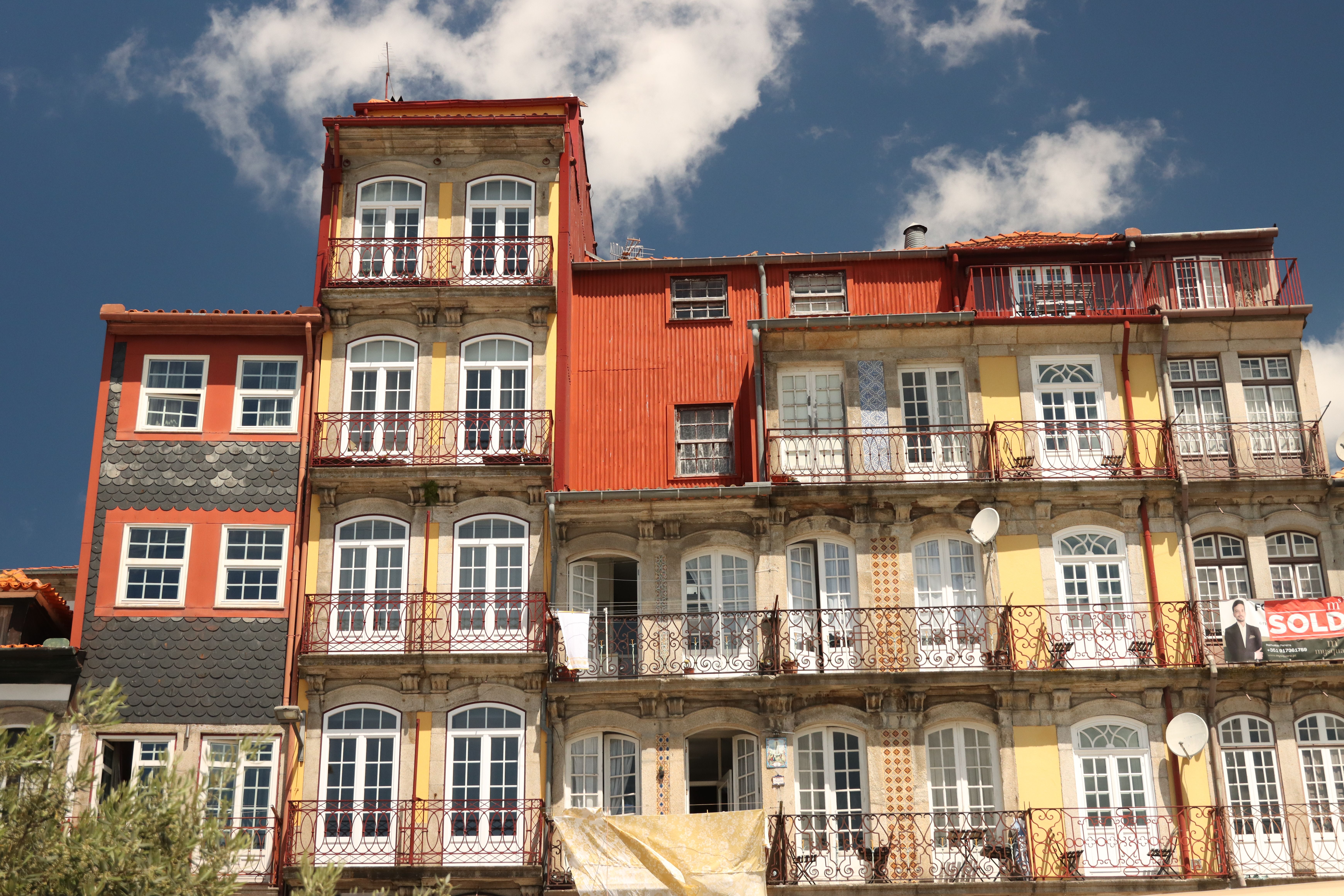 Vibrant and historic apartments in Porto, Portugal bathed in sunlight.