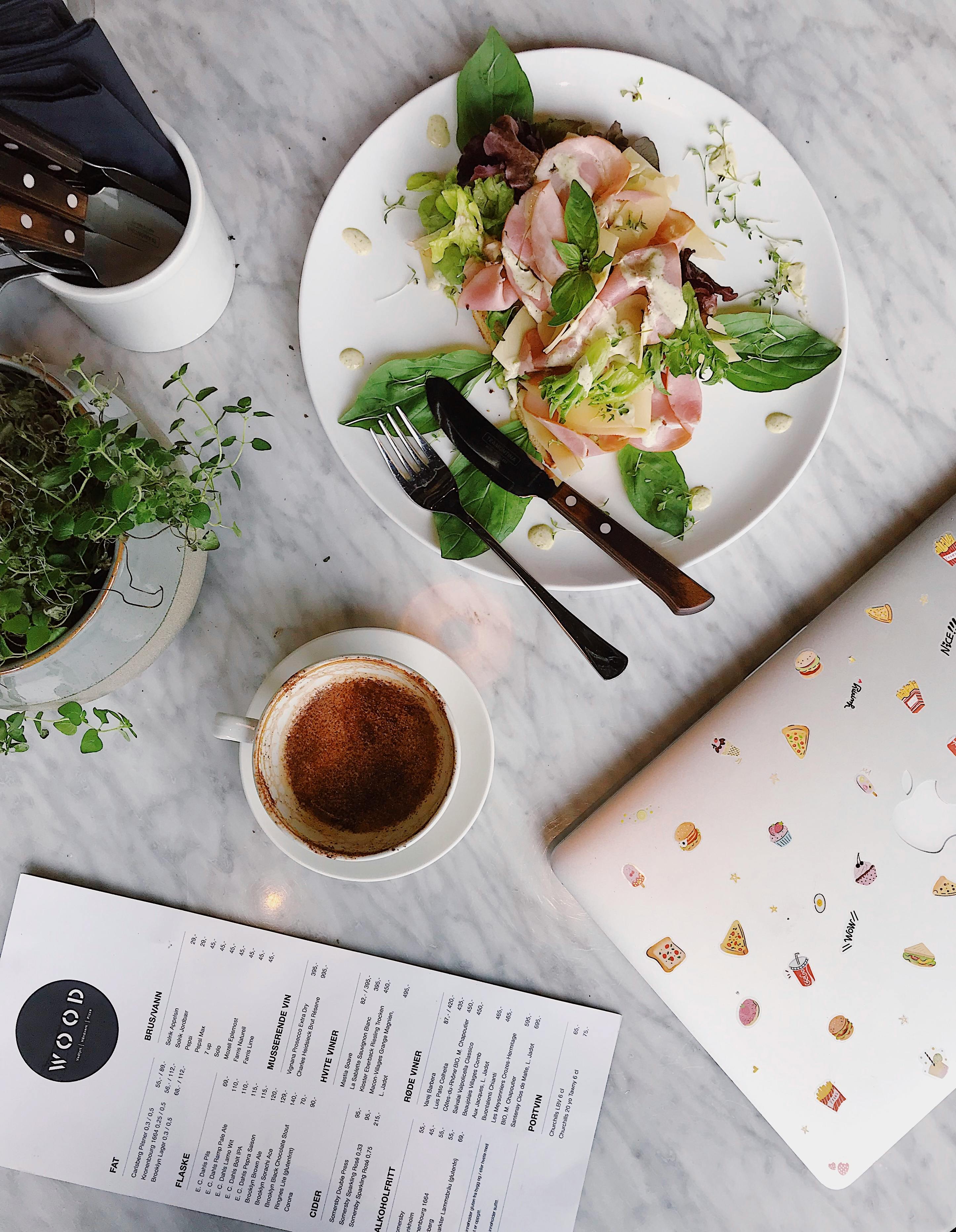 vegetable salad on plate near hot beverage