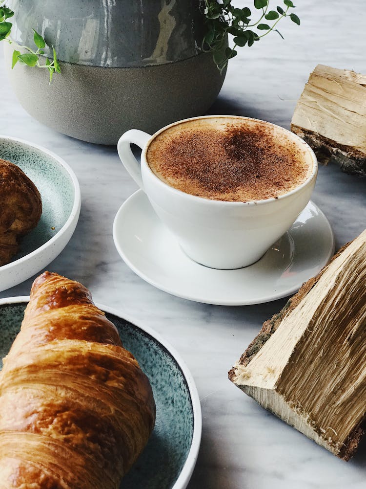 Cup Of Coffee Near Croissant Bread