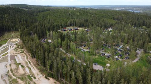 Free Scenic aerial view of a forested village surrounded by lush greenery in Jönköping County, Sweden. Stock Photo