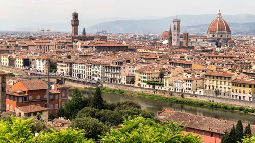 Free A stunning view of Florence, Italy featuring the Duomo and Arno River. Stock Photo