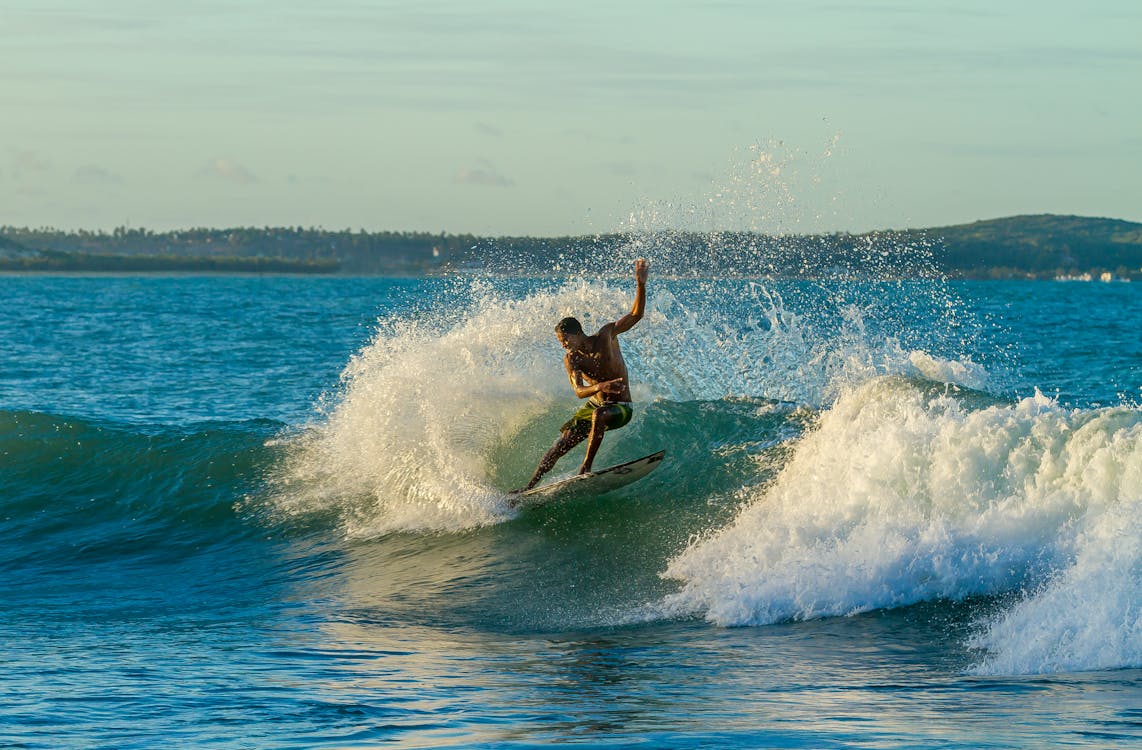 Free Topless Man Surfing on Sea Stock Photo