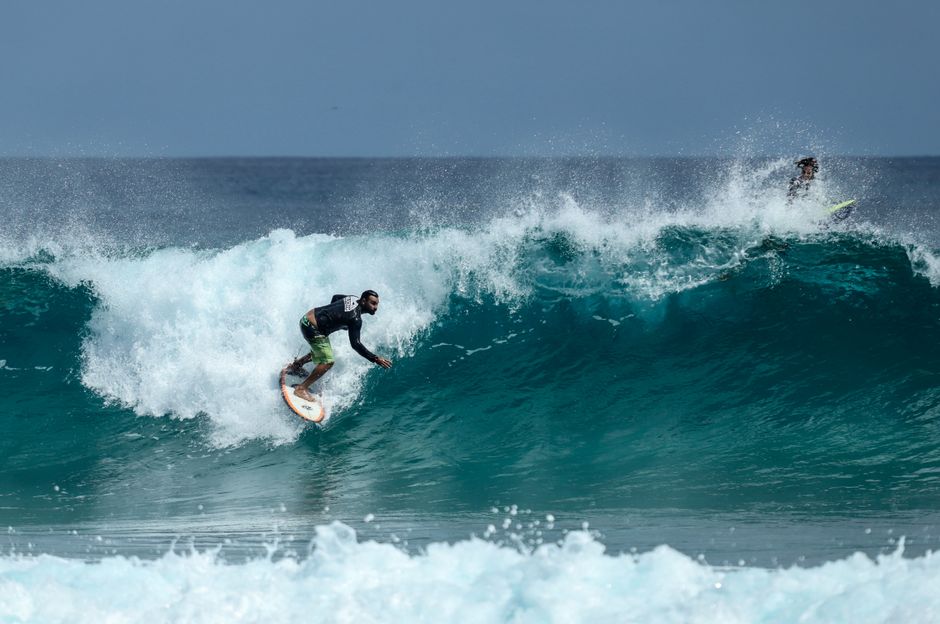 Surfer riding a powerful wave in Brazil's ocean, capturing thrilling surfing action.