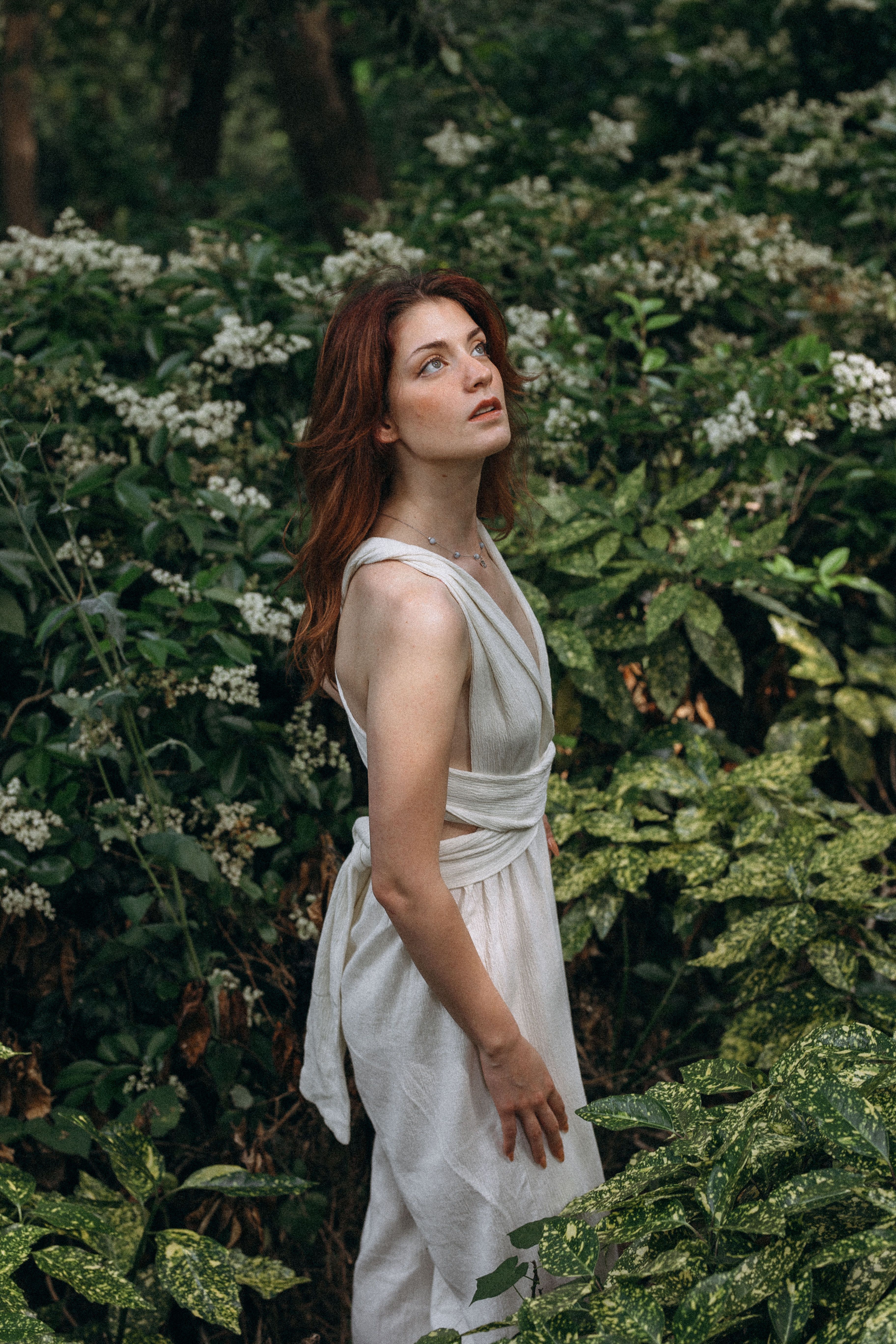 Woman In a White Dress Looking Upwards  Free Stock Photo