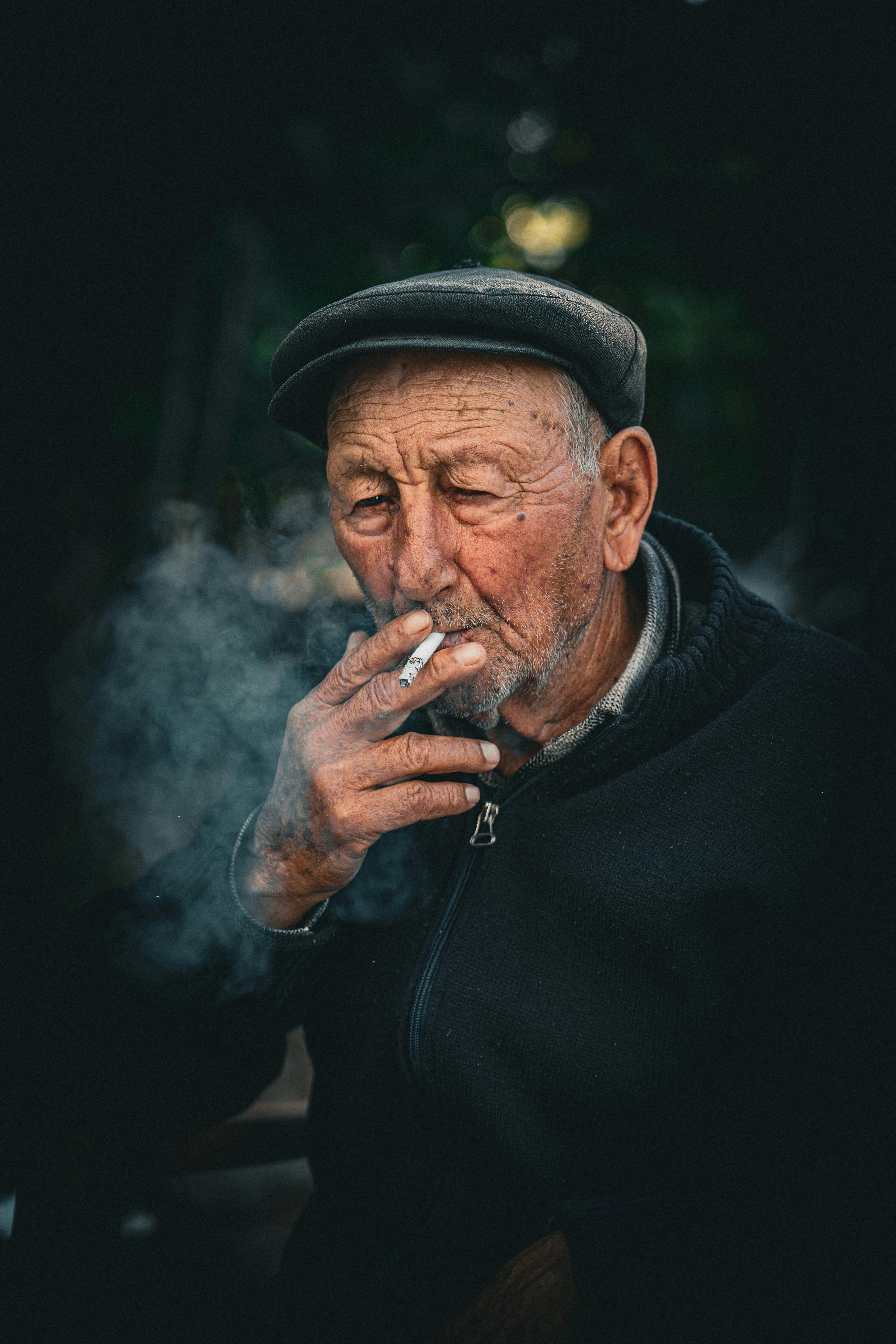 Elderly Man in Hat Smoking Cigarette · Free Stock Photo
