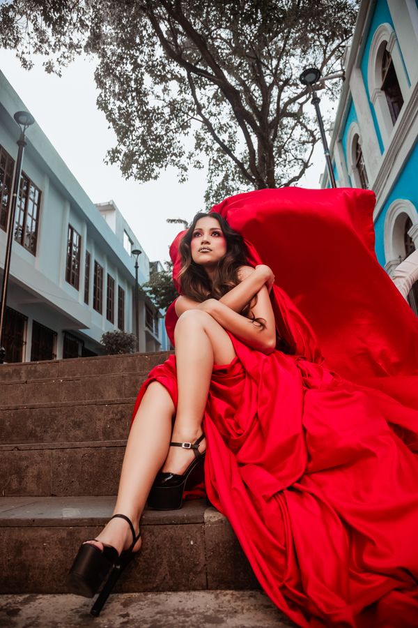 A Woman in Red Dress Sitting on the Stairs · Free Stock Photo