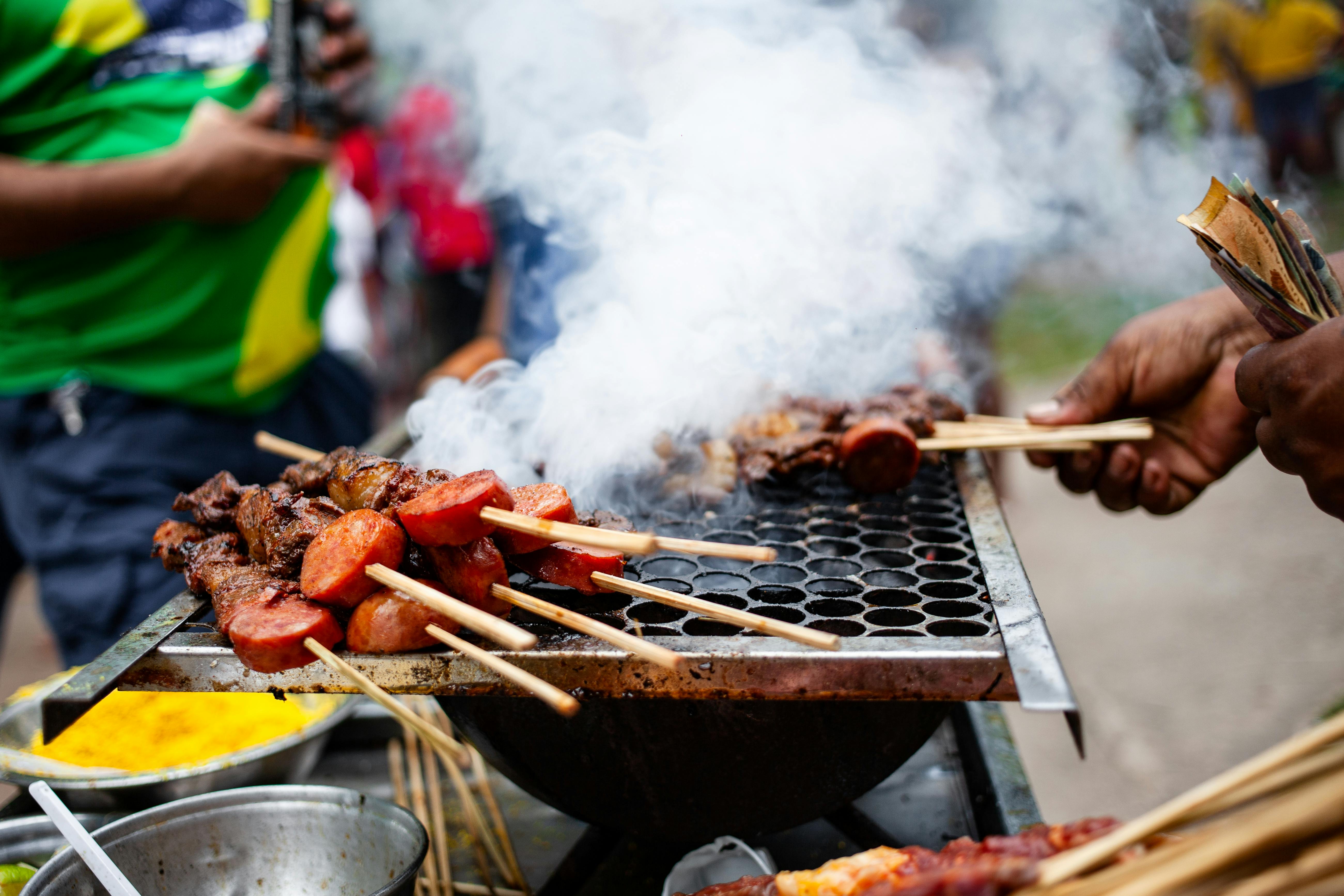 closeup of meat skewers on a grill and smoke