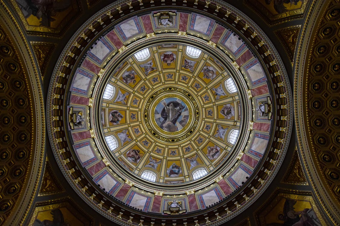 Free From below majestic interior ornamental dome of St. Stephen Basilica with religious paintings and mosaic elements located in Budapest Stock Photo