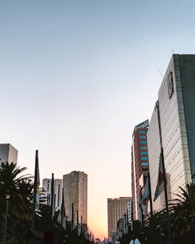 Captivating view of Mexico City's skyline at sunrise, featuring modern skyscrapers and urban landscapes.