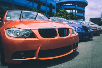 Orange Bmw Car Beside Blue Bugatti Car