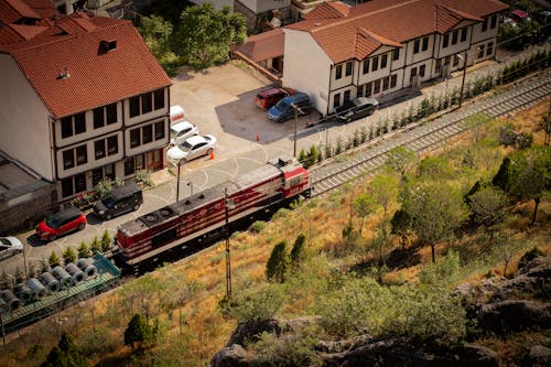 A train is traveling down a track next to a building