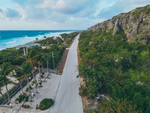 Free Aerial view showcasing the stunning coastline and road beside cliffs in Cayman Islands. Stock Photo