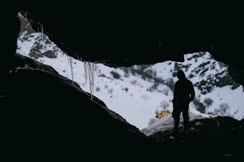 A person standing in the middle of a cave