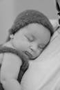 A black and white photo of a baby sleeping