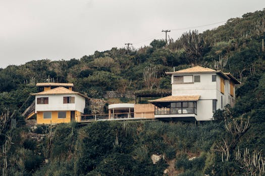 Scenic view of hilltop villas with stunning mountain and lush nature landscape.