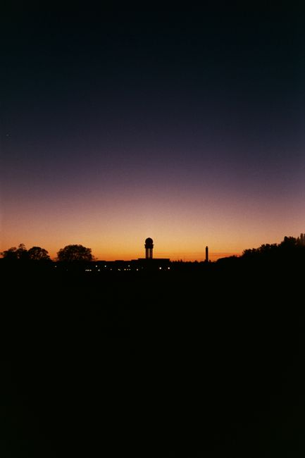 Vibrant sunset casting silhouettes over the Berlin skyline, showcasing a dramatic sky.