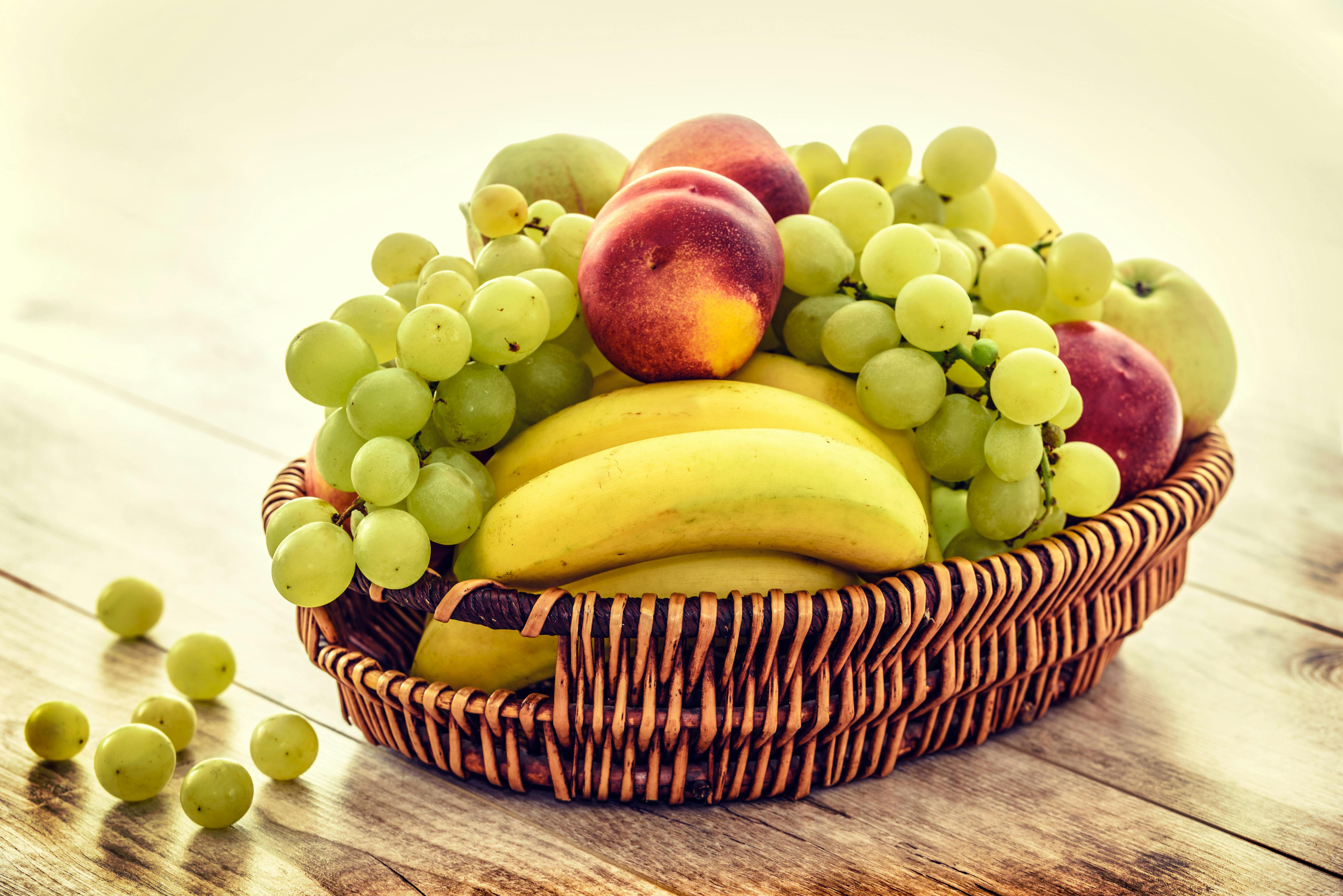 Wicker bowl of mixed fruit.