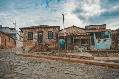 Road Signs in Front of Brown Stone Houses