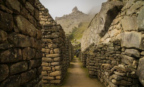 Free Explore the historic stone corridors of Machu Picchu, a marvel of Incan architecture. Stock Photo