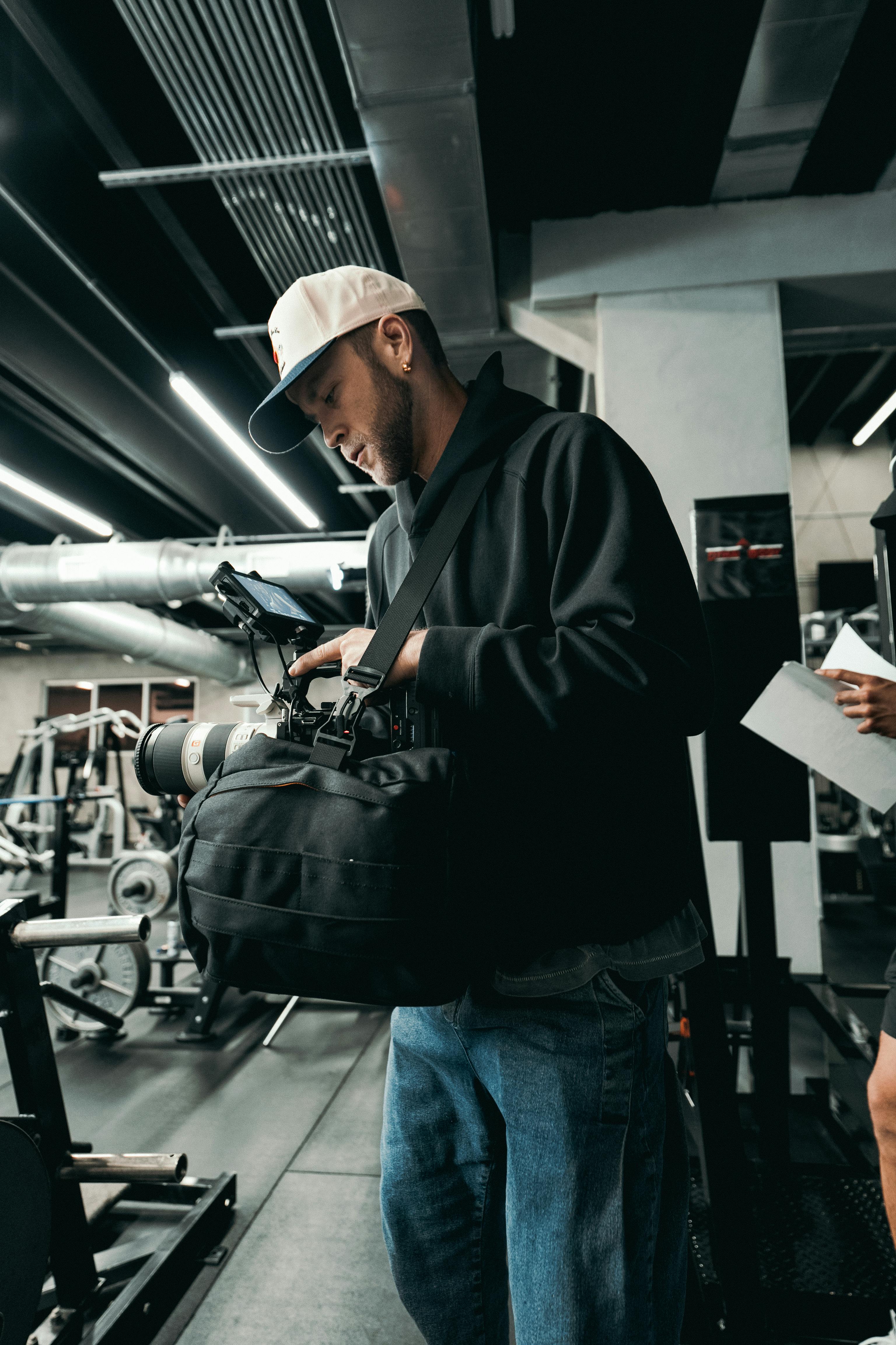 a man in a gym with a bag and a woman