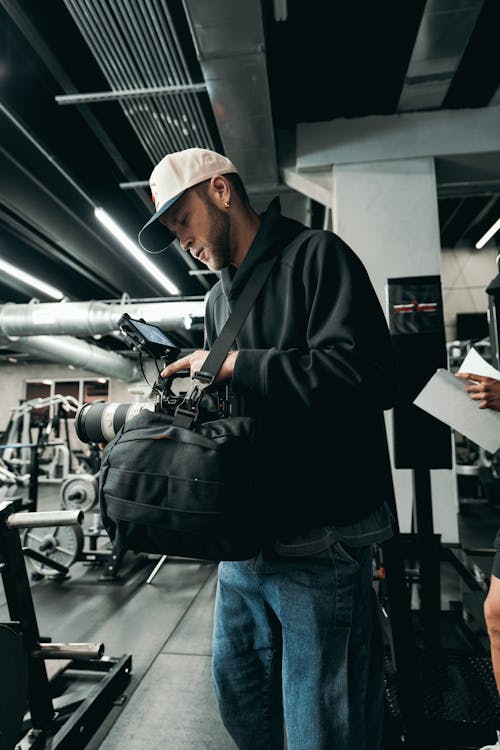 A man in a gym with a bag and a woman