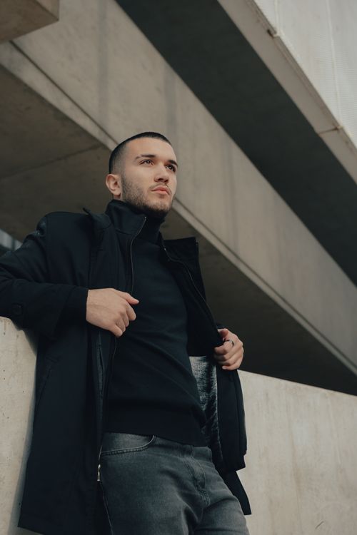 Free Stylish young man in a modern urban environment, exuding confidence. Stock Photo