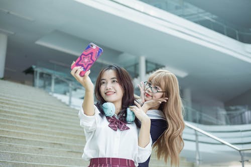 Two girls taking a selfie on the stairs