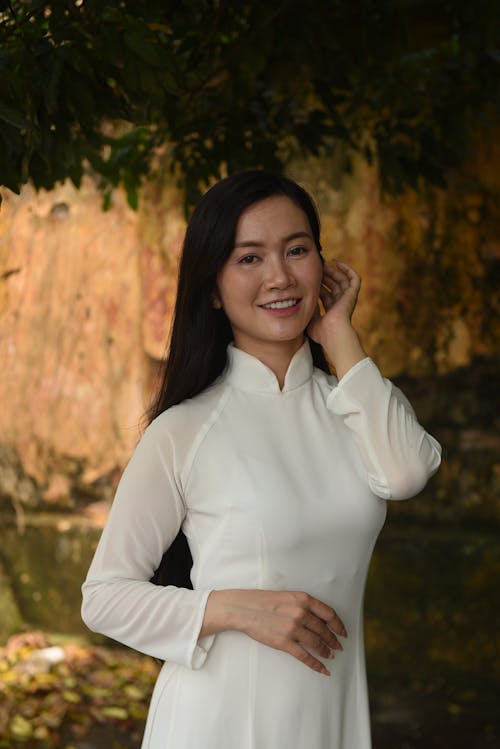 A woman in a white dress posing for a photo