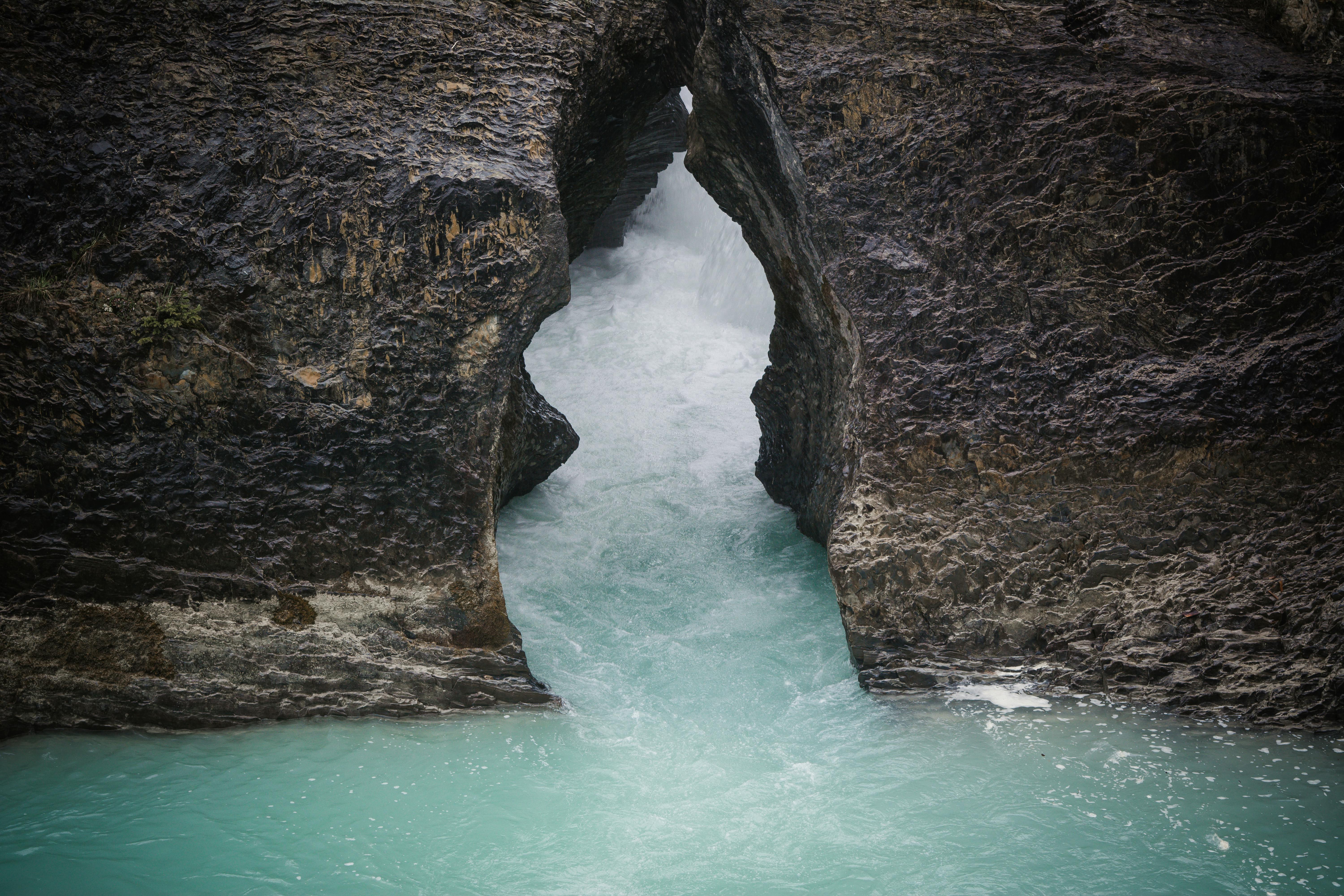 A stunning view of eroded rocks framing a creek with flowing turquoise water.