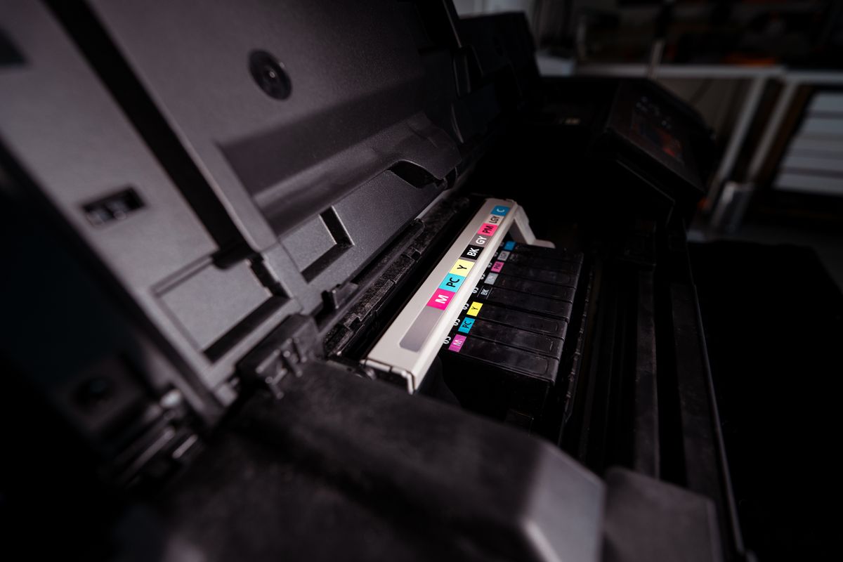 Toner cartridge being fitted inside a laser printer