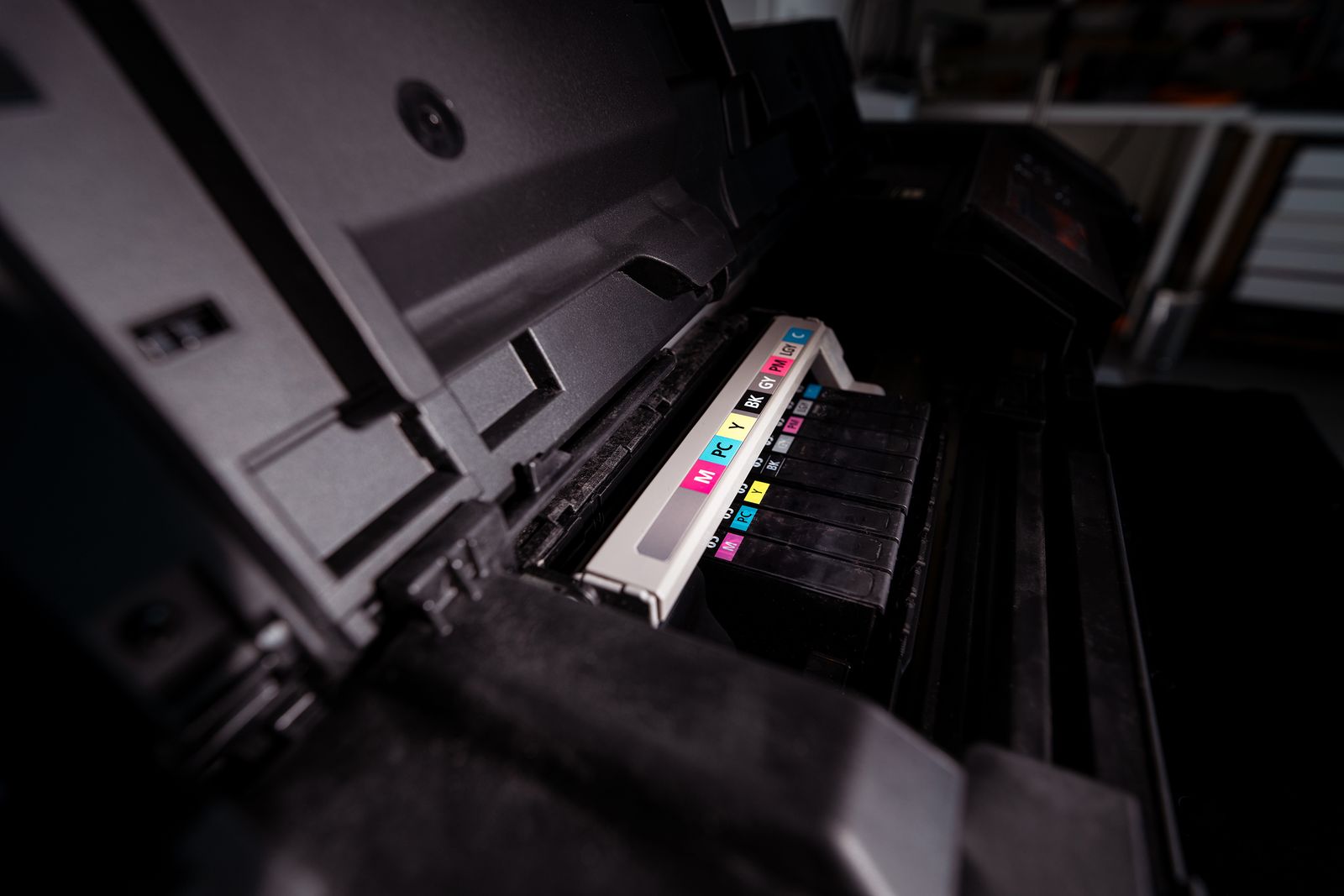 Close-up of a printer with visible CMYK ink cartridges