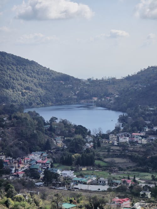 A view of a small town and lake from a hill