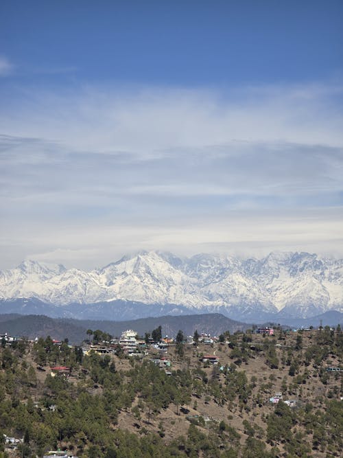 The snow capped mountains are seen from a hilltop