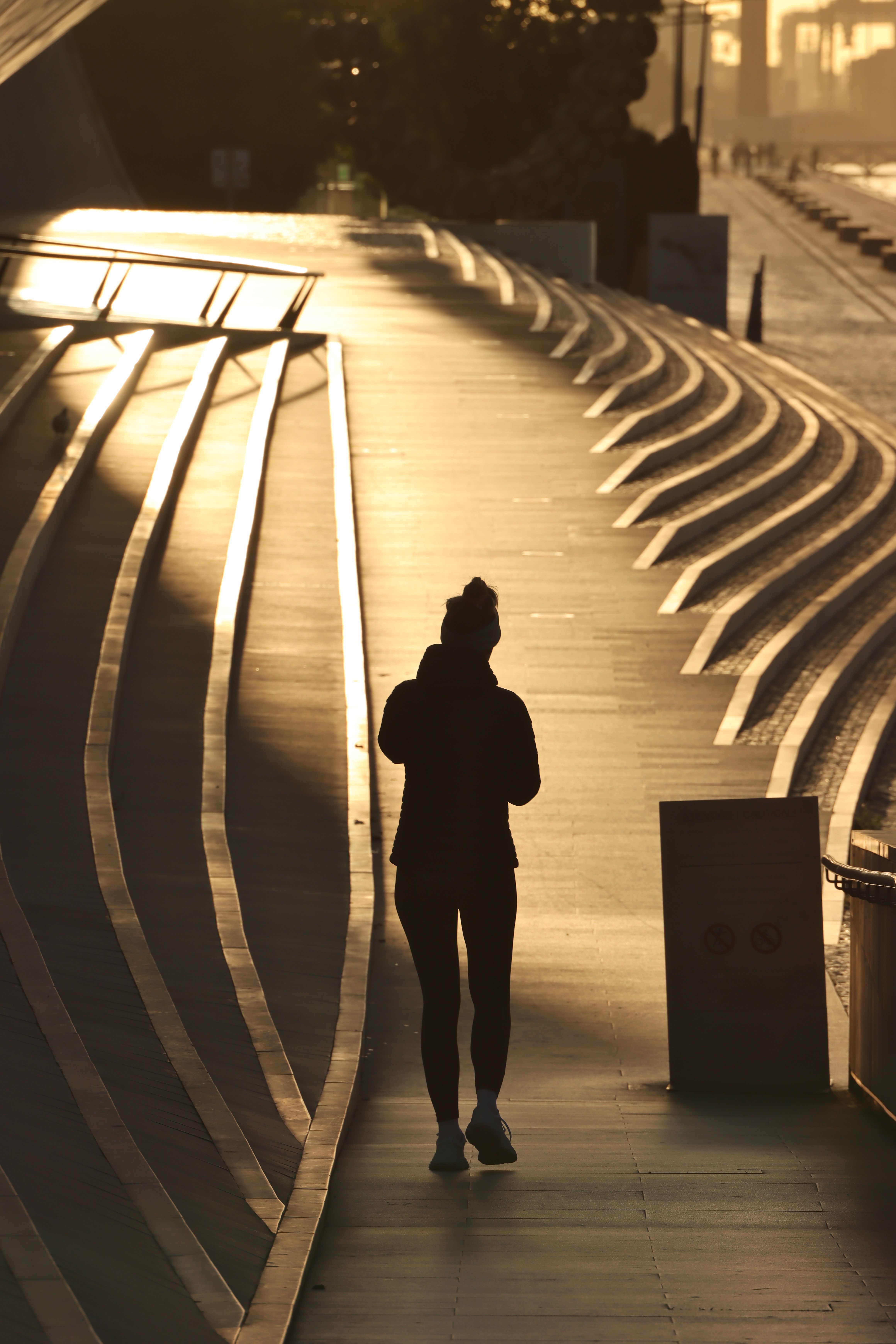 Silhouette of Woman Walking on a Street During Sunset · Free Stock Photo