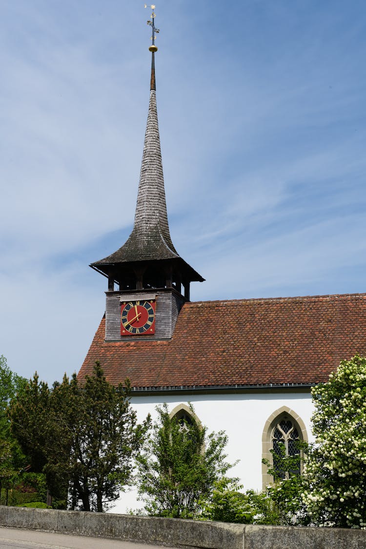 Rustic Church With A Clock And A Spire