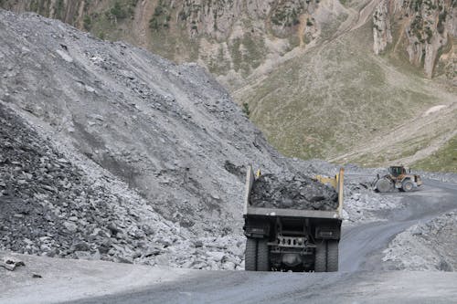 A truck is driving down a mountain road