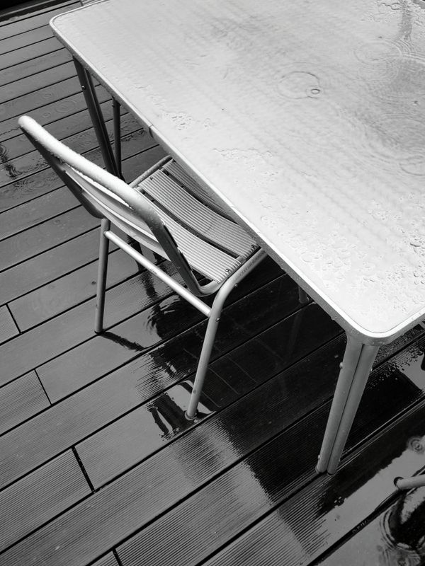 A table and chair left out in the rain - The First Step of the Drift