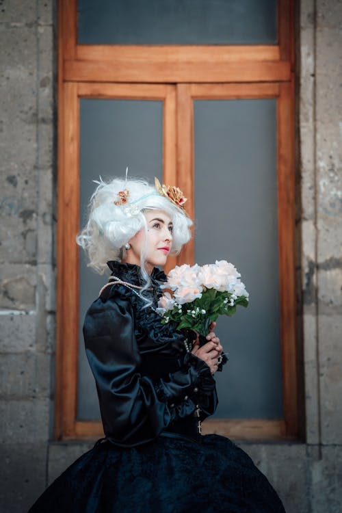 Woman in Dress and Wig and with Flowers