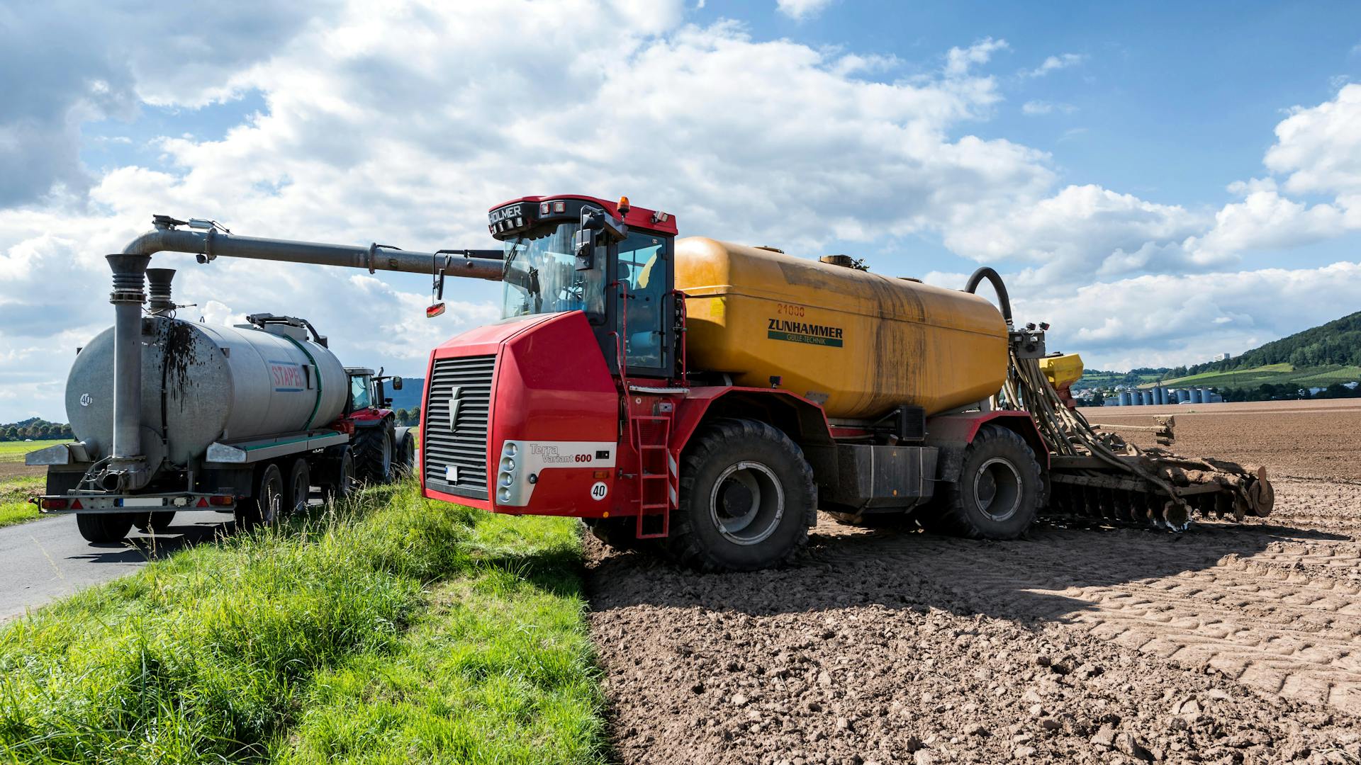 Machinery and Truck with Tank on Field