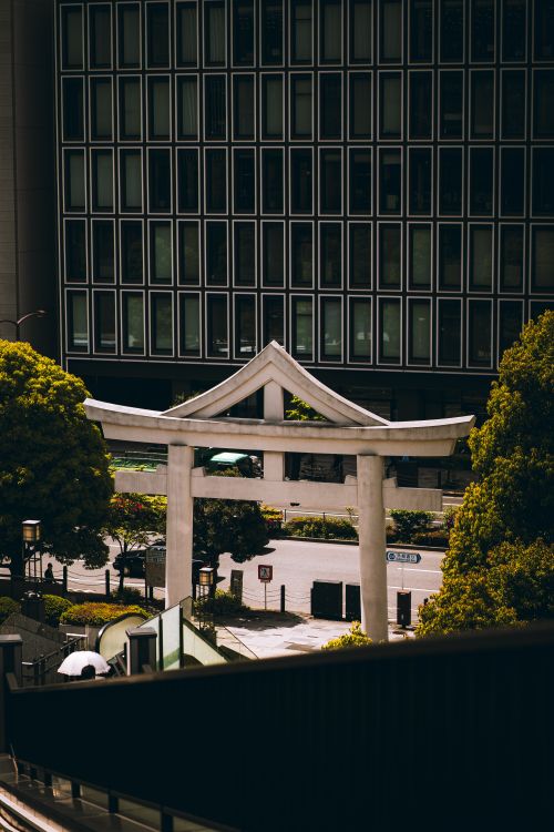 Free A beautiful torii gate amidst modern architecture in Tokyo, Japan. Stock Photo