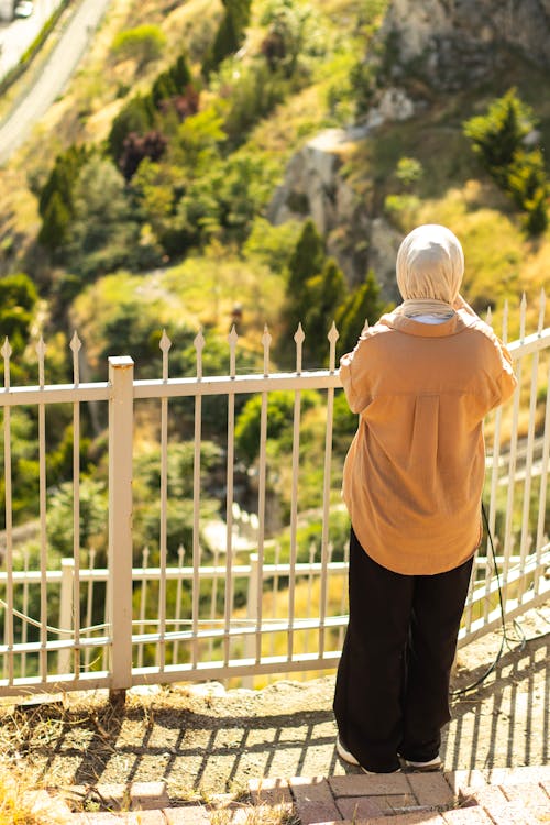 Elderly woman looking at the view from the top of a hill