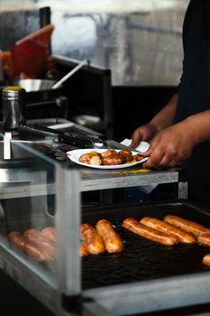 Delicious sausages being grilled at a Berlin street market, showcasing authentic German cuisine.